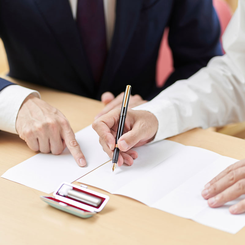 Person in Los Angeles, CA signing documents with a lawyer guiding them for probate law services
