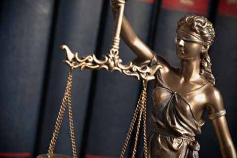Scales of Justice Statue near law books in an Ogden, UT office