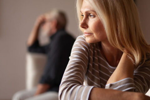 Upset couple sitting apart on sofas, hinting at a fight, represented by experienced annulment lawyers in Ogden, UT