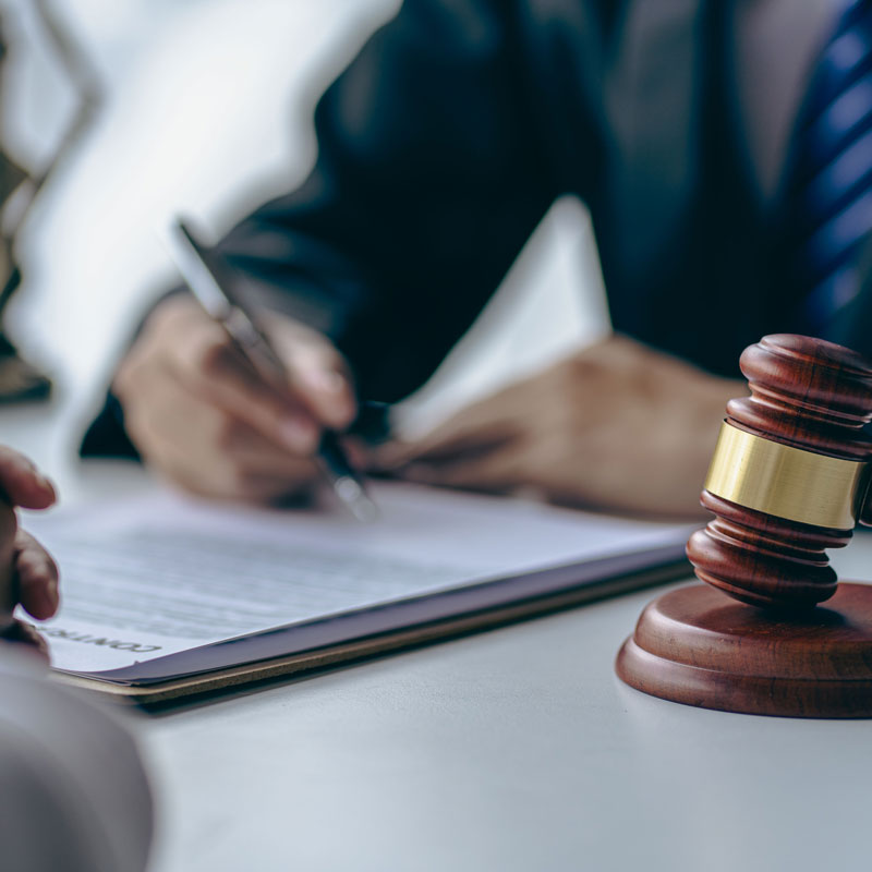 Lawyer and client signing annulment papers in Ogden office, gavel on table.