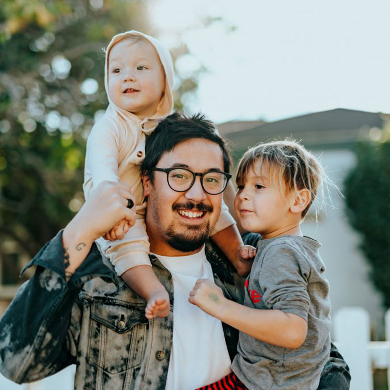 Dad joyfully holding his sons, showcasing paternity rights in Los Angeles, CA