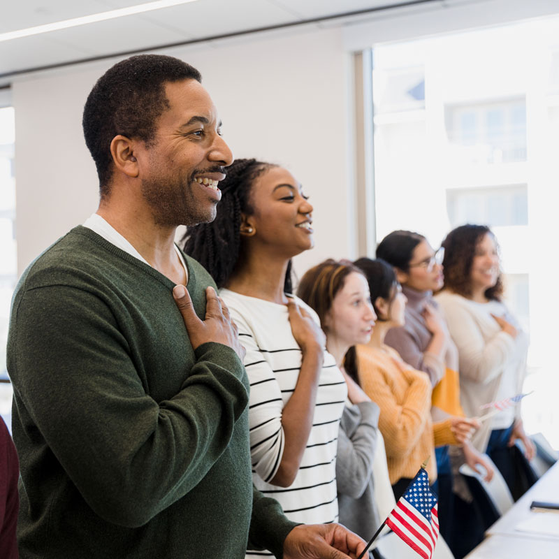 People in Los Angeles, CA taking citizenship oath for USA with hands over hearts