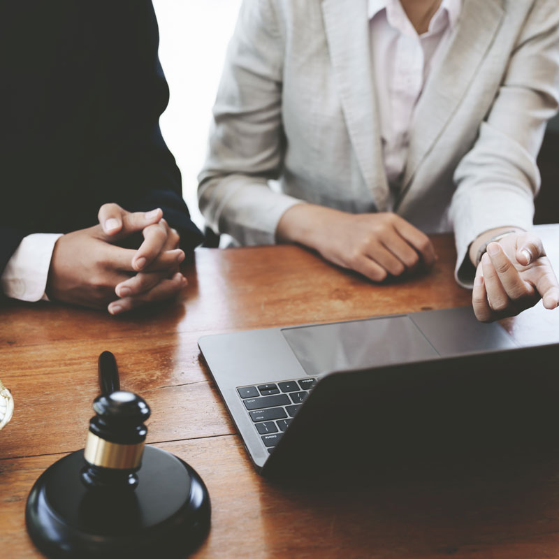 Lawyer and client discussing trust litigation process in Ogden, UT office
