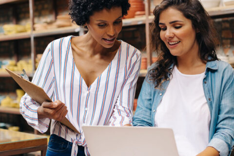 Two girls in Ogden, UT discussing small business opportunities on a laptop