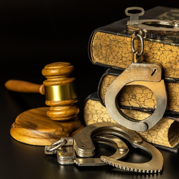 Judge gavel and handcuffs with legal books - Criminal Defense Lawyer in Utah