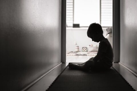 Abused Child Sitting in the Dark Hallway - Child Abuse Lawyer in Ogden, UT