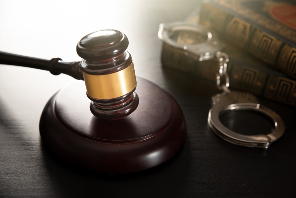 Gavel, handcuffs, and law books on a table symbolize drug trafficking defense in Ogden, UT