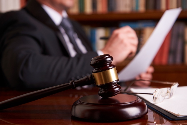 Defense lawyer in Ogden, UT studying a document next to a gavel