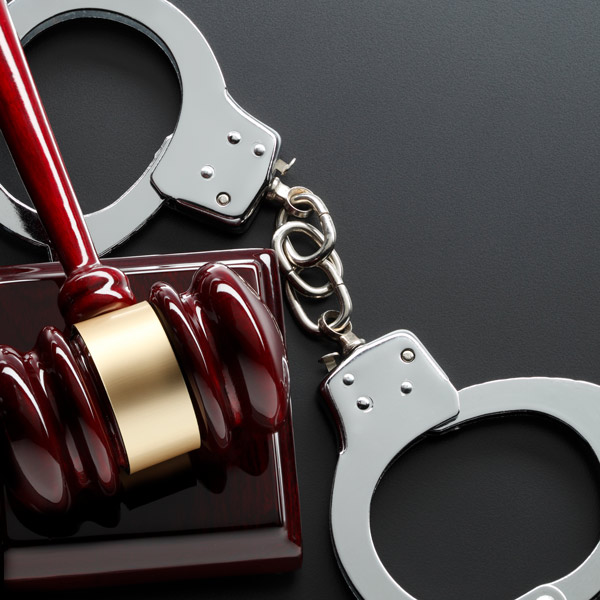 Handcuffs and a wooden gavel representing post conviction relief and registry removal services in Ogden, UT