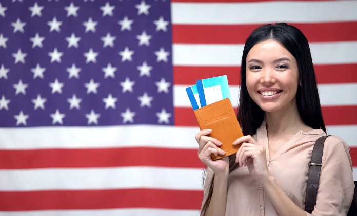 Smiling woman with Passport moving to USA – Richards & Richards Law Firm