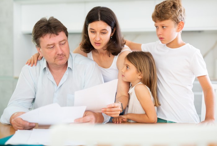 Upset Father with his children on reading DACA application