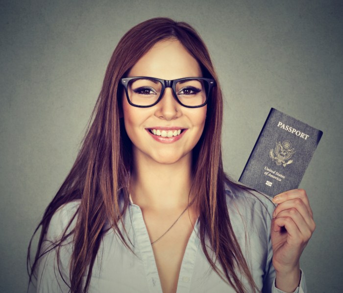 young happy woman with her USA passport after naturalization